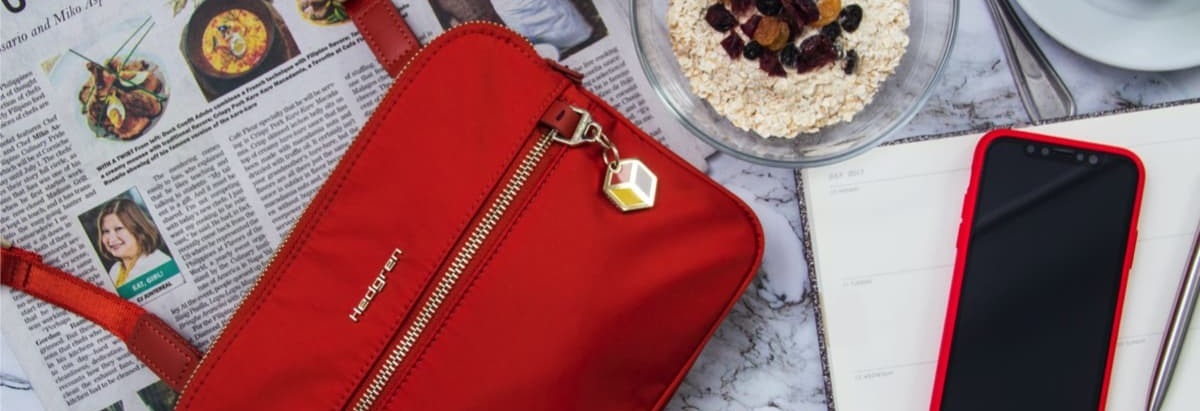 magazine, red handbag and smartphone in red case